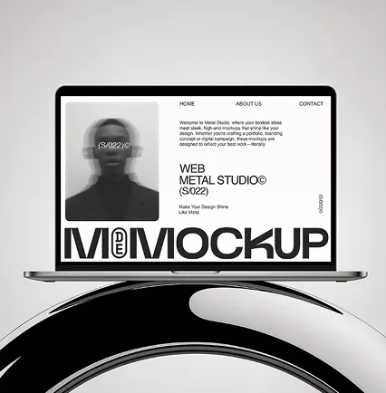 Laptop displaying Metal Studio website mockup with minimalist black and white design on modern curved surface with "MOCKUP" text prominently shown