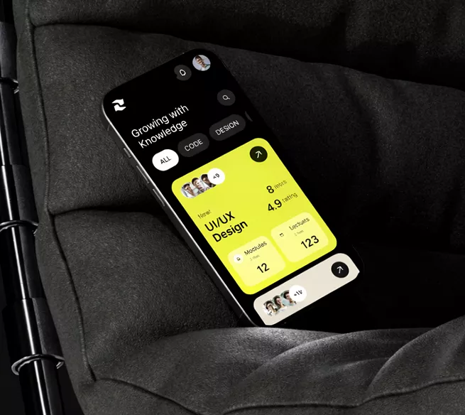 Smartphone on dark fabric showing UI/UX design learning app with bright yellow interface displaying course modules, user stats, and progress metrics